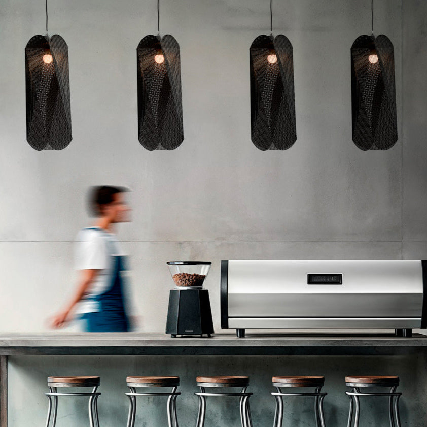 Modern kitchen with a stainless steel coffee machinel, pendant lights.